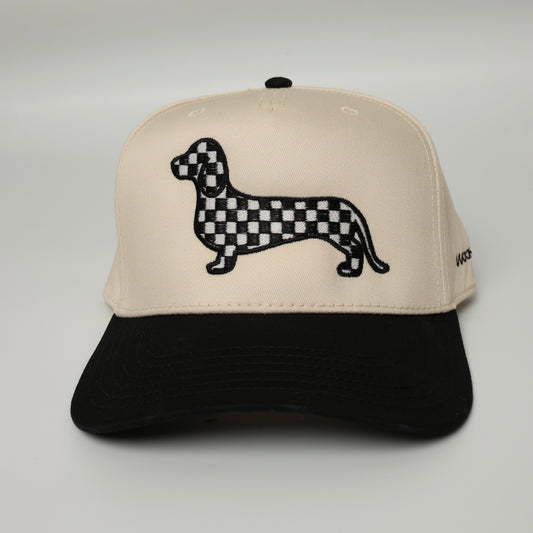 Black and white checkered dachshund embroidered on a black and beige canvas hat