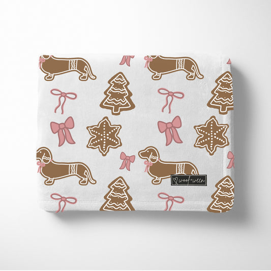 Pink dachshund Christmas blanket with bows and gingerbread dachshunds