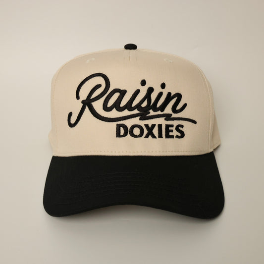 Beige and black dachshund hat with 'Raisin Doxies' text