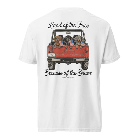 White t-shirt with a graphic of a red Jeep with dogs holding American flags and text on a white background