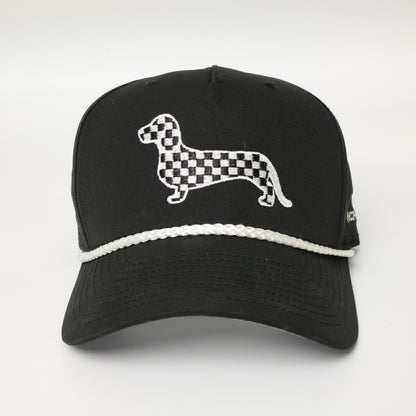 Black and white checkered dachshund embroidered on a black hat with white rope