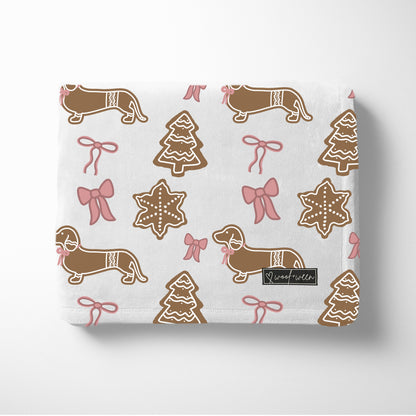 Pink dachshund Christmas blanket with bows and gingerbread dachshunds 