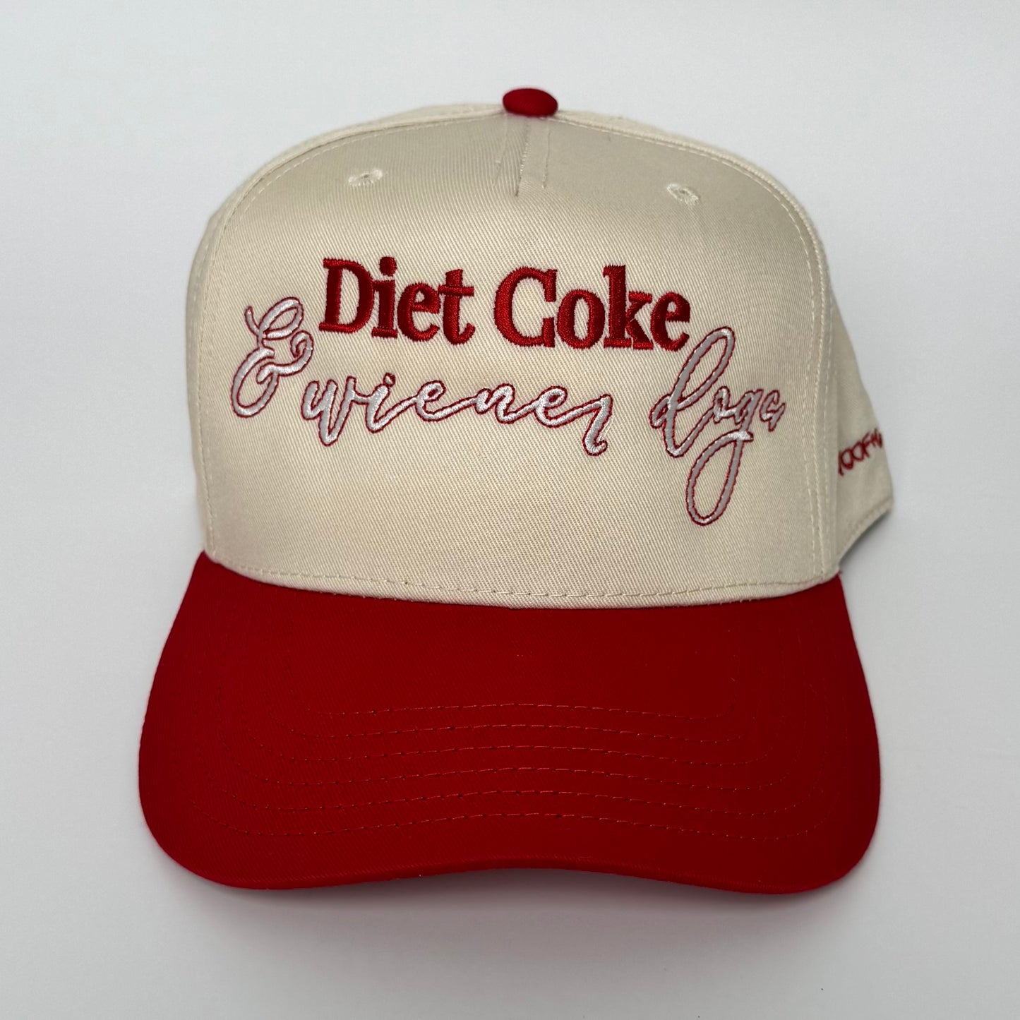 Cap with 'Diet Coke & Wiener Dog' text on a white background