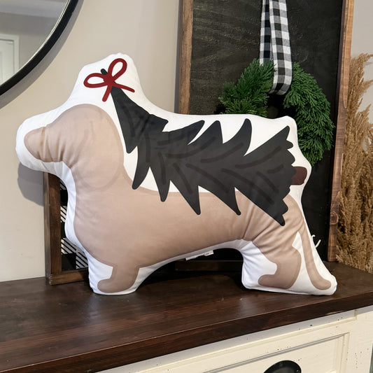 Dachshund Christmas pillow that has a design of a dachshund carrying a Christmas tree on its back