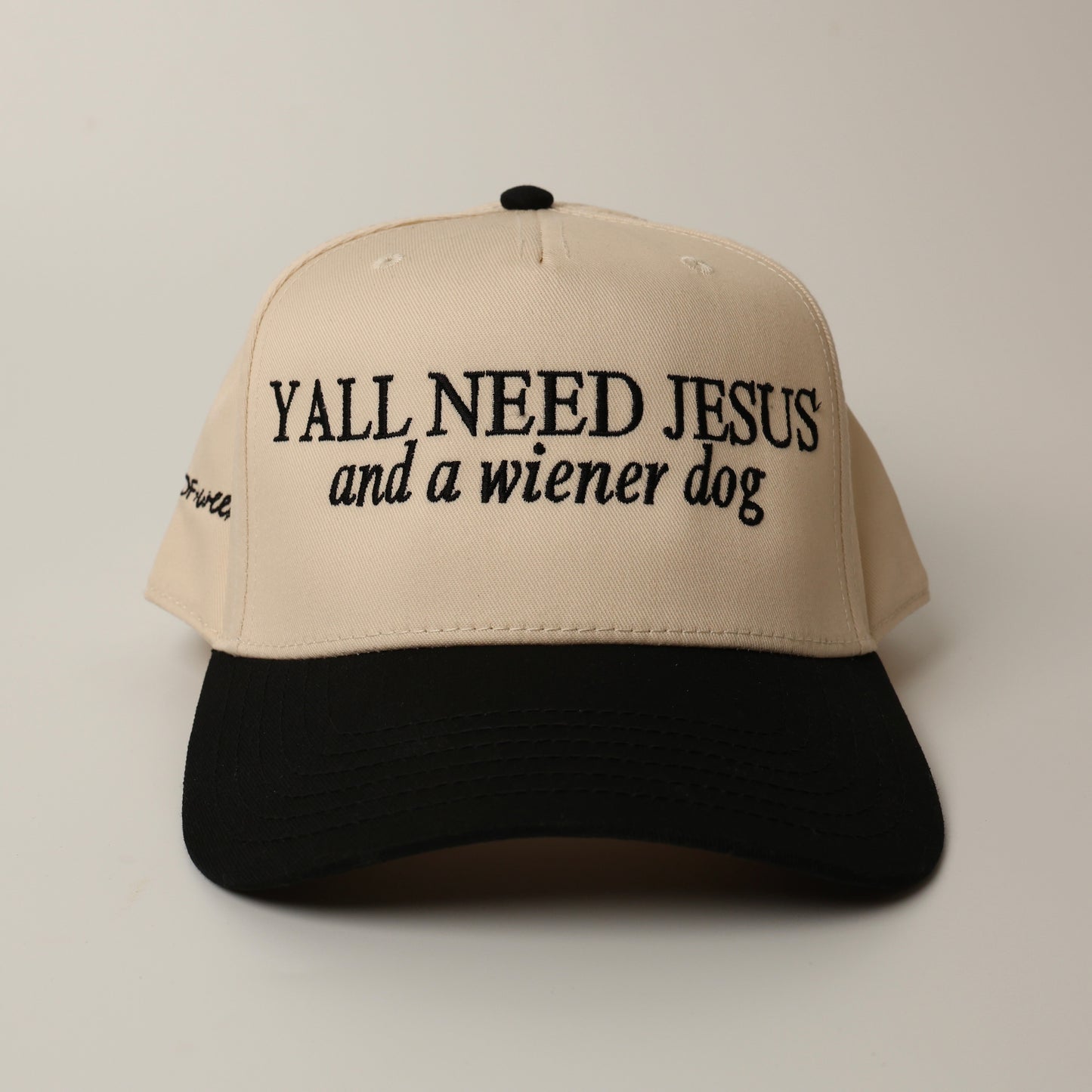 Beige and black woof+ween dachshund hat with text 'YALL NEED JESUS and a wiener dog' 