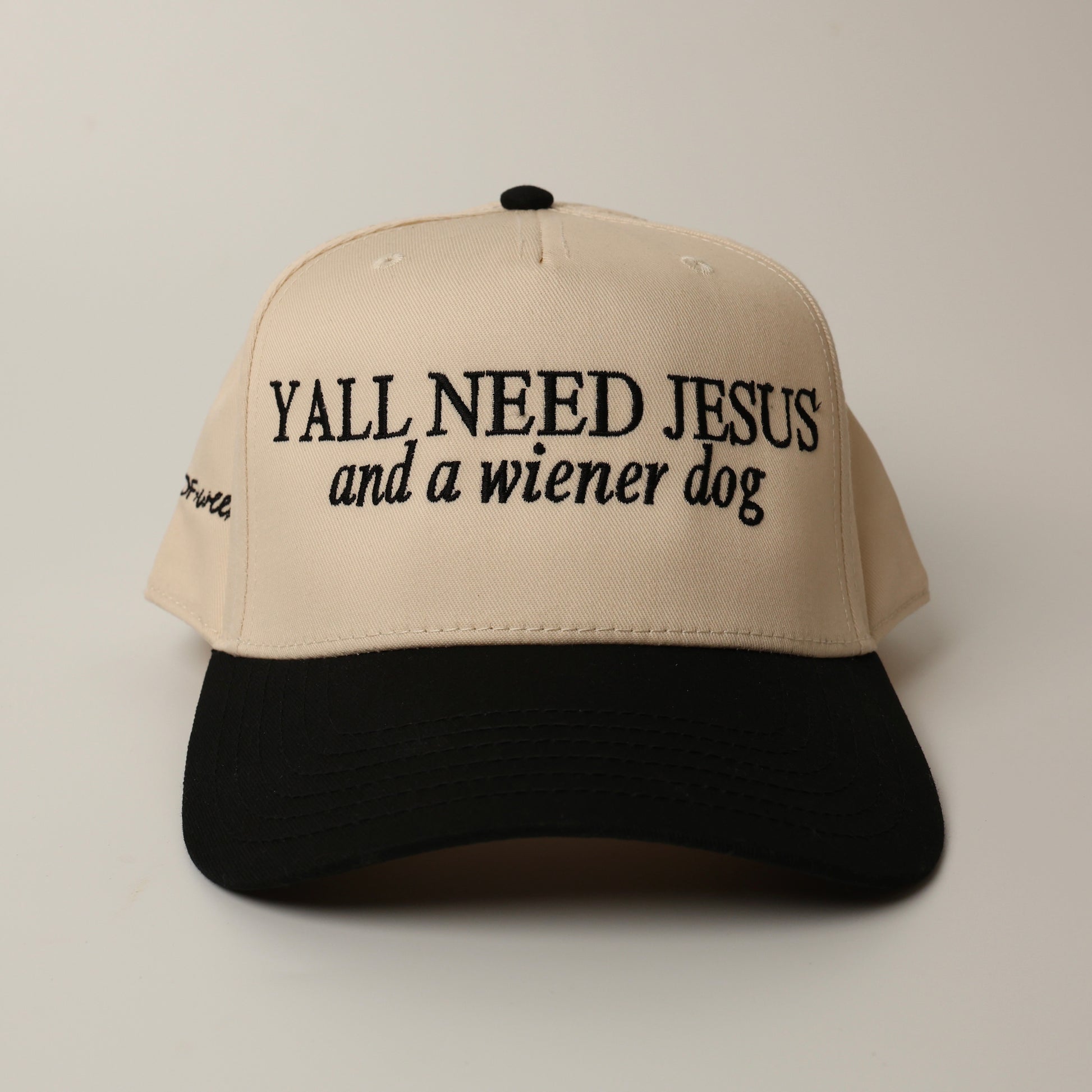 Beige and black woof+ween dachshund hat with text 'YALL NEED JESUS and a wiener dog' 