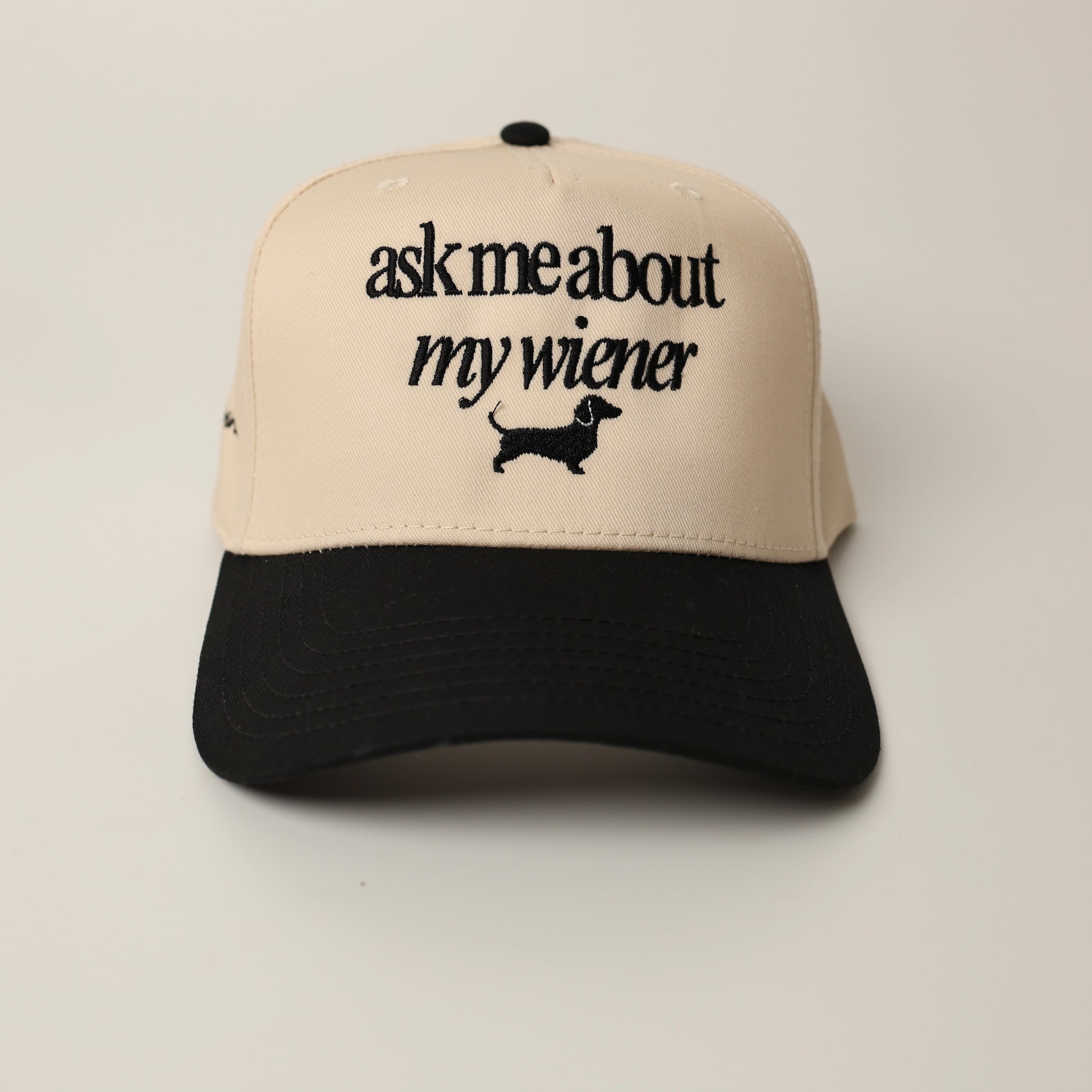 Beige and black woof+ween hat with text 'ask me about my wiener' 