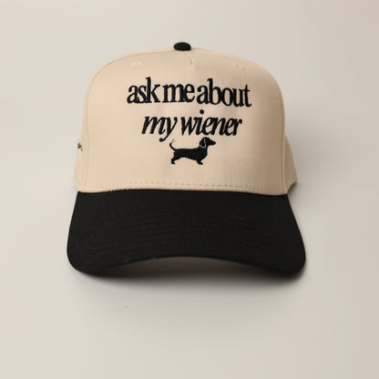 Beige and black woof+ween hat with text 'ask me about my wiener' 
