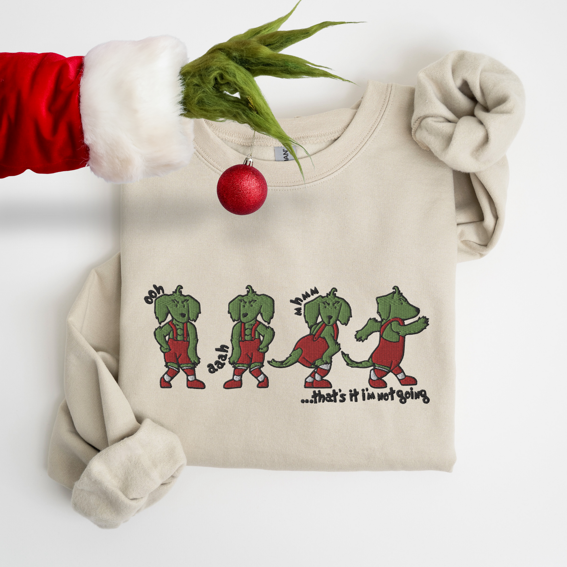 Embroidered tan crewneck sweatshirt with a dachshund grinch design 