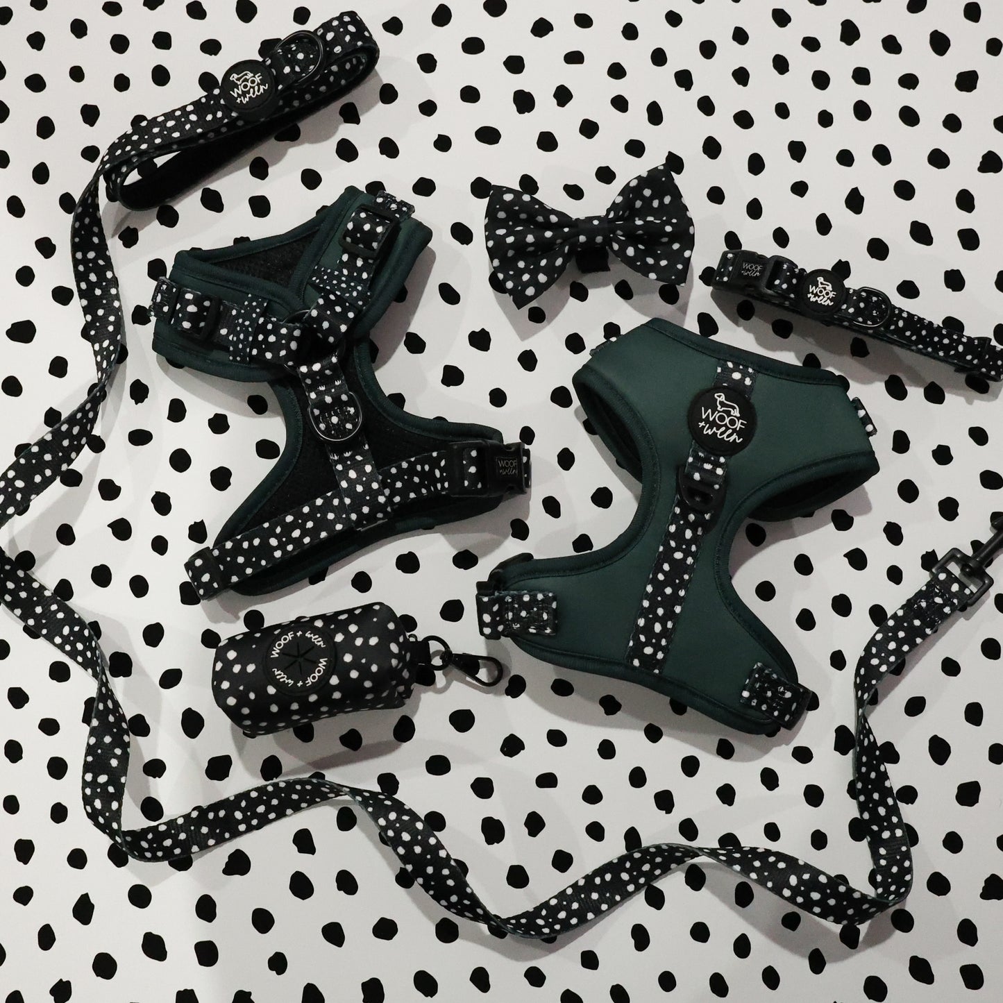 green dog harness from woof and ween with polka dots and a dog leash, collar, bow and waste bag holder