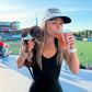 girl holding her dachshund wearing a woof+ween hat that says hot girls have wiener dogs
