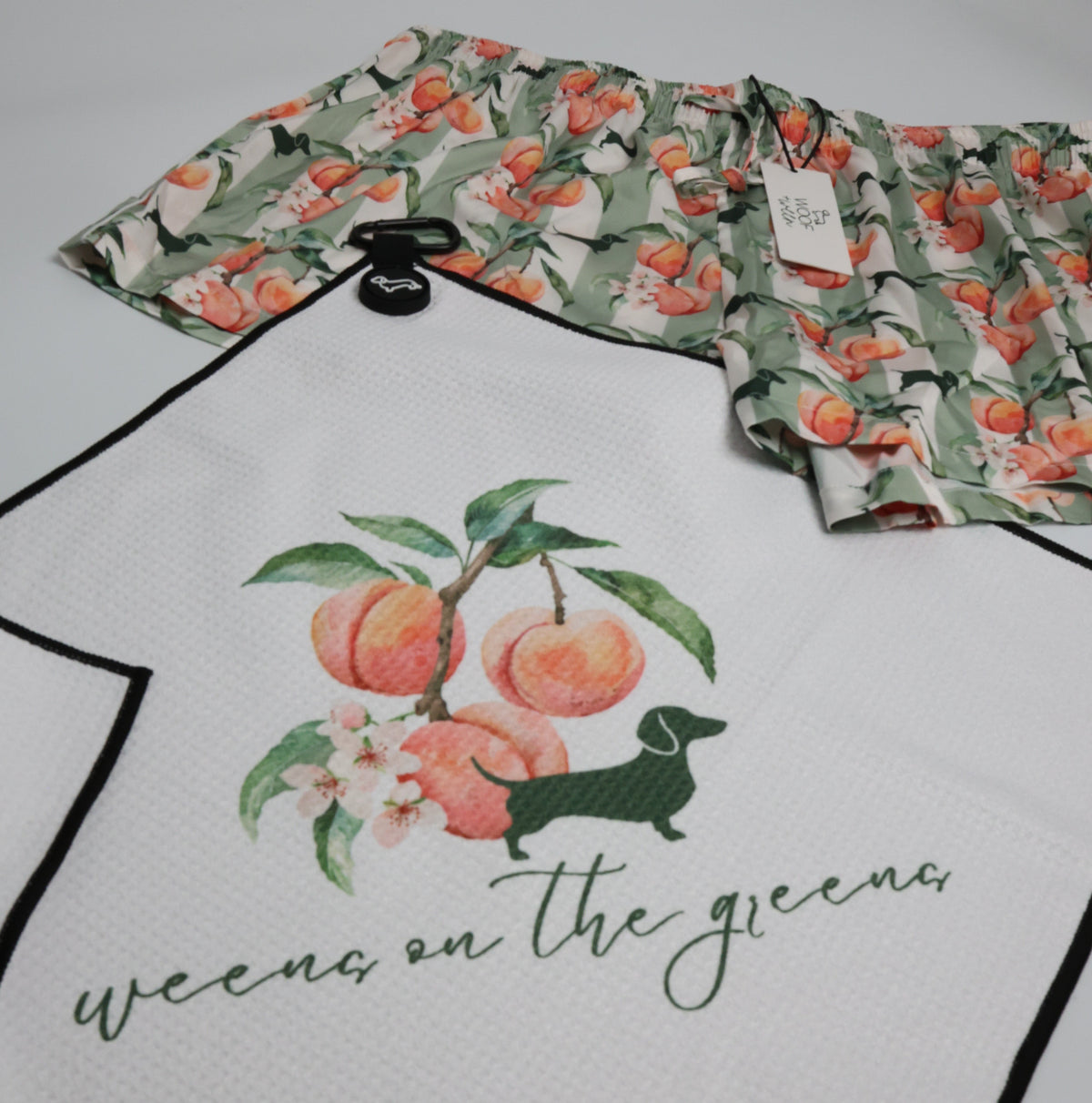 Peach Doxie golf towel clipped to golf bag