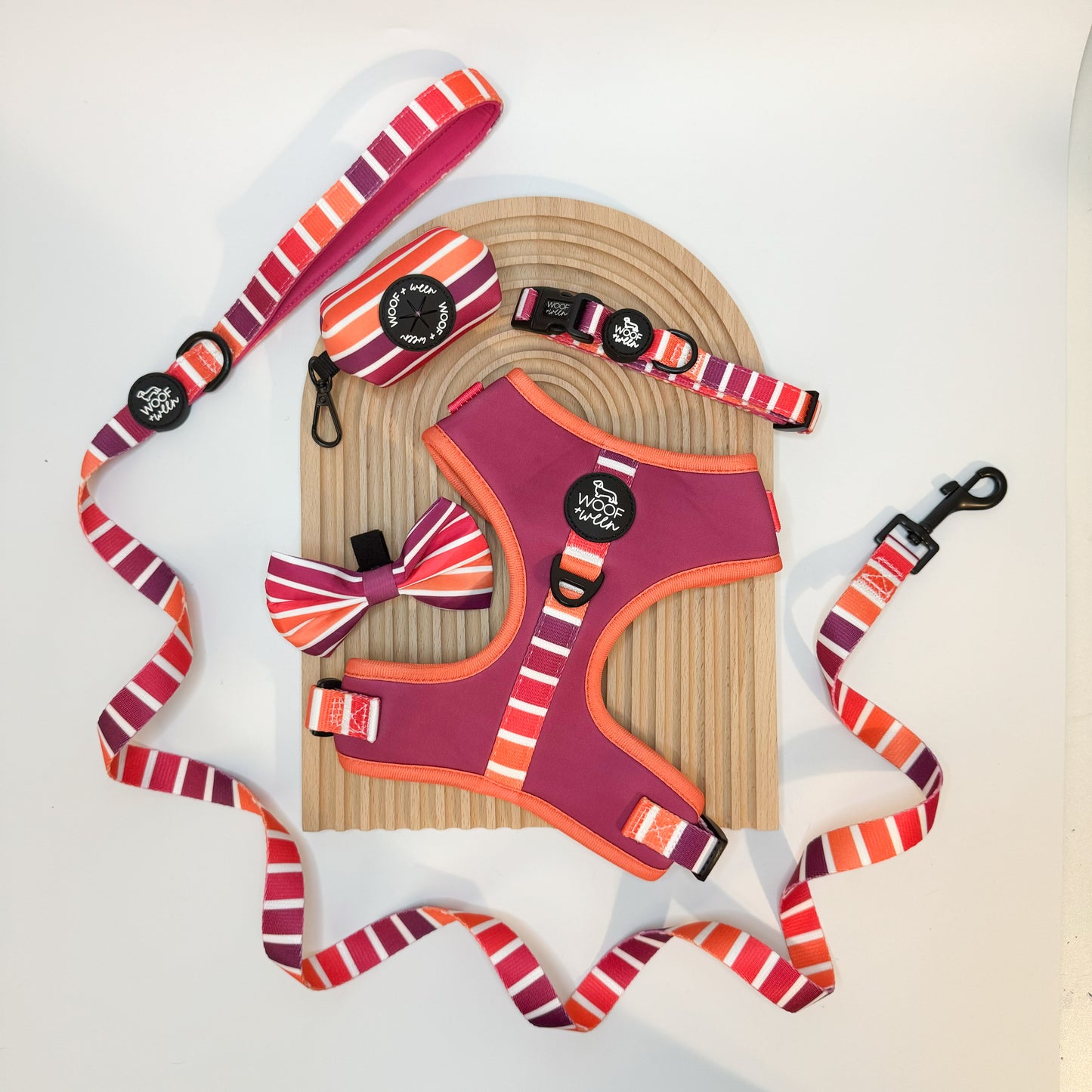 Dog harness, leash, and bow tie set with pink and orange striped pattern