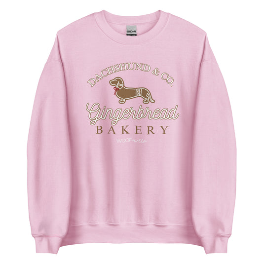 A pink sweatshirt with a gingerbread dachshund design for Christmas