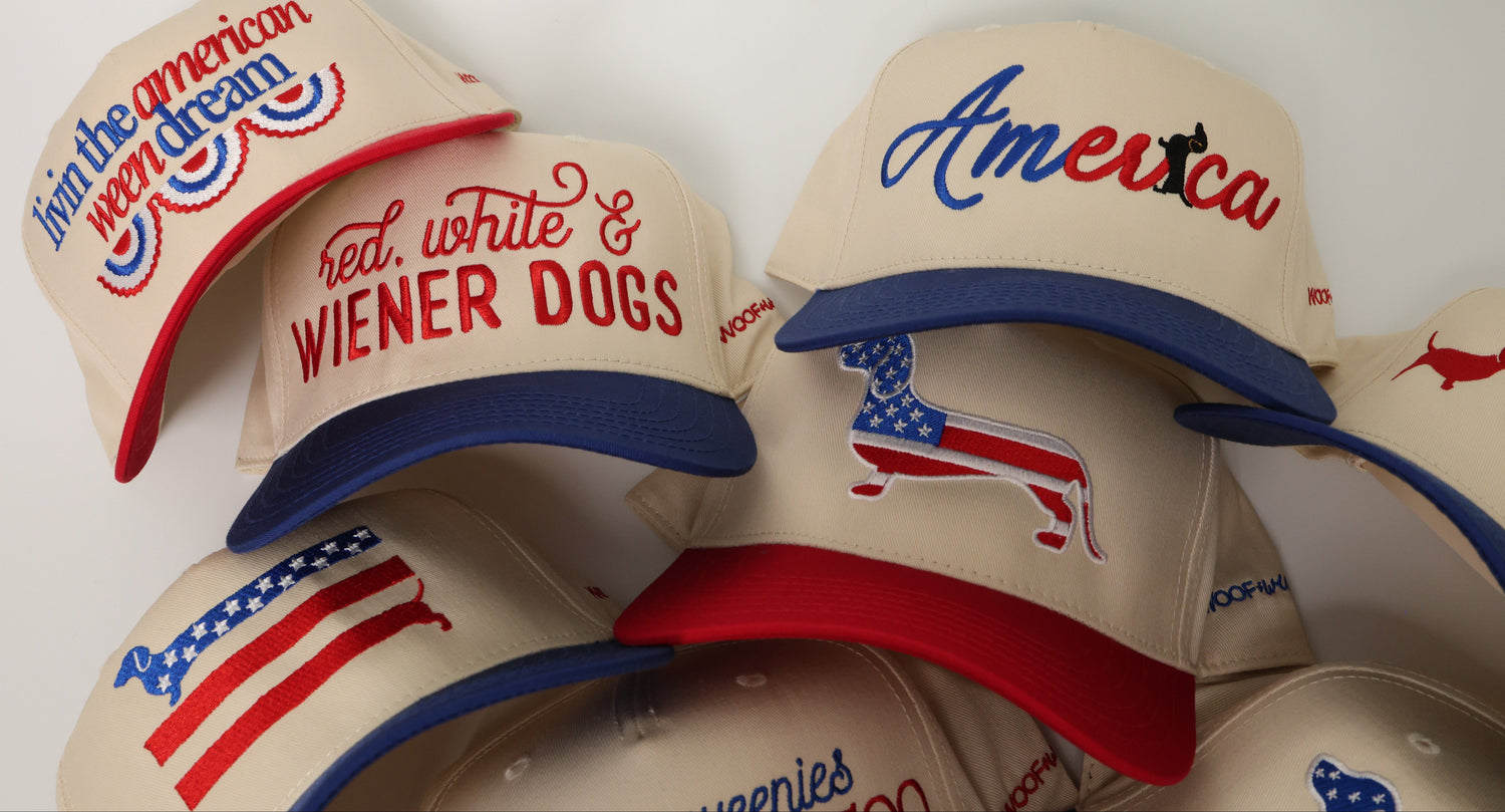 Collection of baseball caps with American-themed dachshund designs on a white background