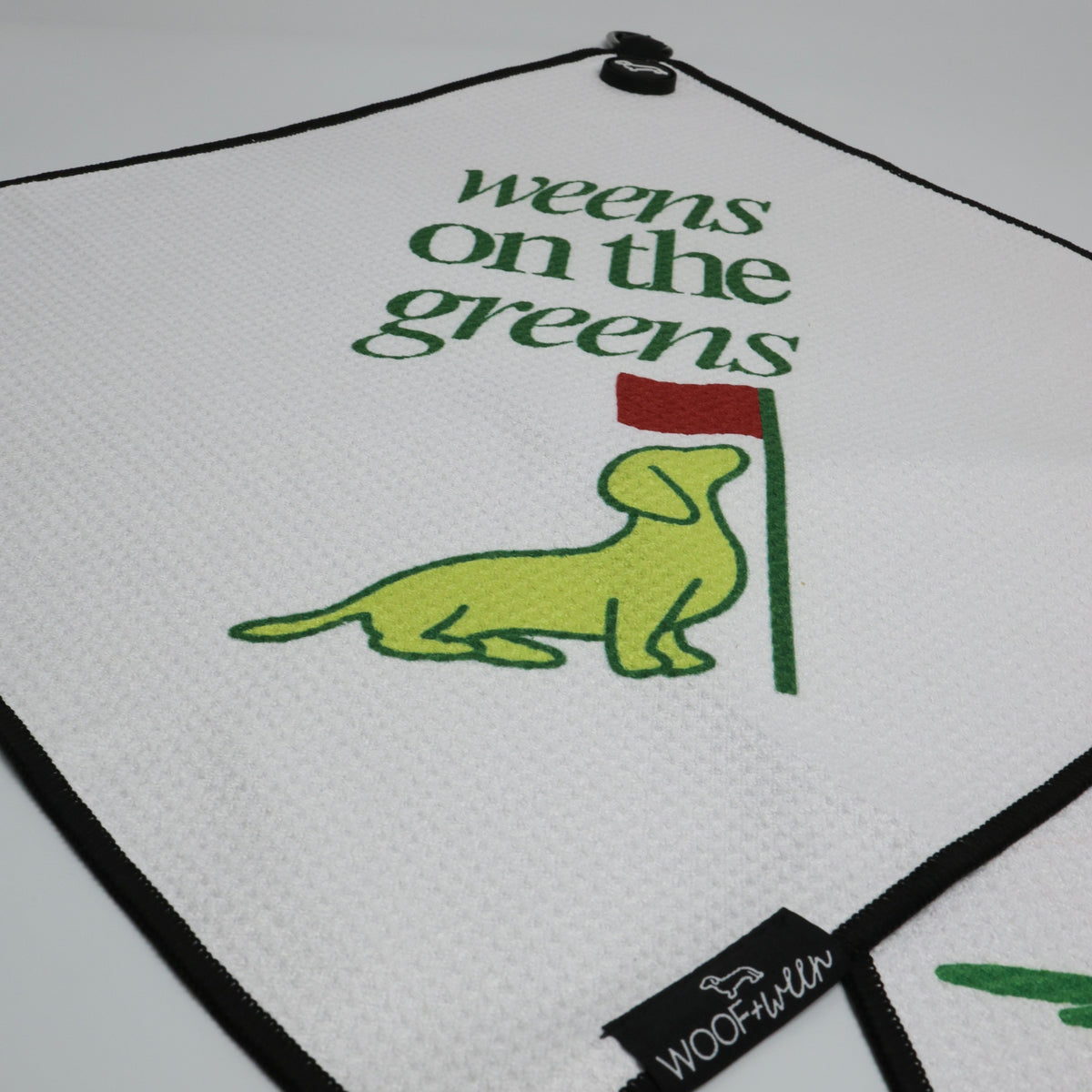 Weens on the Greens golf towel clipped to golf bag