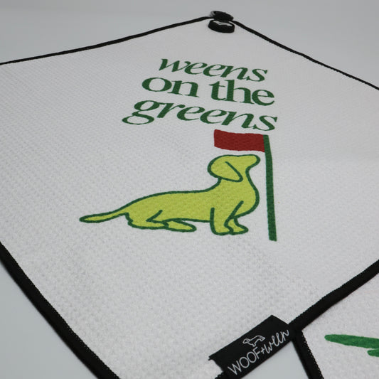 Weens on the Greens golf towel clipped to golf bag